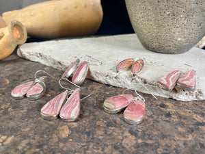 The most beautiful rhodochrosite we've ever seen. Every piece tells a story, and all earring pairs feature perfectly matched stones set in sterling silver bezels. Finished with sterling silver hooks.