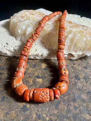 A stunning necklace of graduated antique red coral from the Himalayas, purchased in northern Thailand in 2004 and finished with a sterling silver clasp. This strand has 88 beads including a magnificent centre bead and weighs 55 grams. Length 45.5 cm