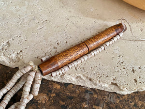 This is a vintage wood sewing needle case from northern Thailand, from the Ahka tribe. This beautiful, old and rare vintage piece is highly decorated and made from bamboo, etched, stained with red betel juice and finished with a long fringe of Jacob's tears. Length 24.5 cm with fringe, length of tube 9 cm
