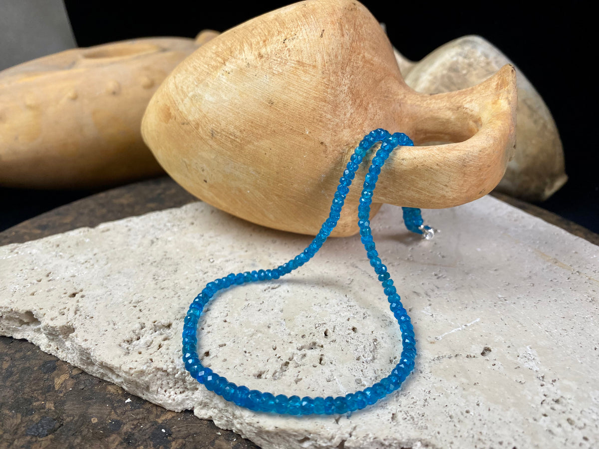 Short dark blue apatite necklace featuring graduated faceted apatite beads finished with a sterling silver lobster clasp. This is a lovely statement necklace that matches any skin tone or clothing. These stone are natural and not heat treated Measurements: 39.7 cm total length 