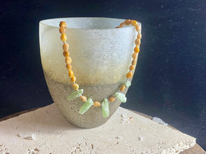 A polished pebble golden ocean jasper short necklace featuring spears of natural, unpolished green kyanite and sterling silver. Our necklace is finished with a sterling silver hook clasp and findings. Length 38 cm