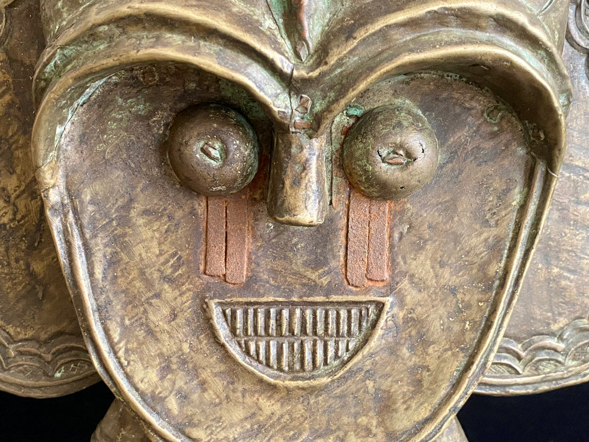 Mbulu-ngulu or funerary reliquary protective figure. Kota people, Gabon, West Africa. Mid to late 20th century. Wood with copper and brass decorative overlay. Height 54 cm, width at widest point 30 cm.