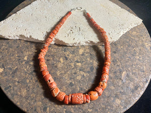 A stunning necklace of graduated antique red coral from the Himalayas, purchased in northern Thailand in 2004 and finished with a sterling silver clasp. This strand has 88 beads including a magnificent centre bead and weighs 55 grams. Length 45.5 cm