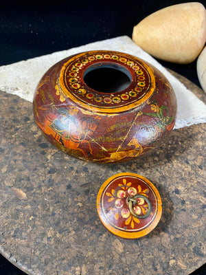 A beautiful low oval lidded bowl or box, traditionally called an opium pot because of its shape. Crafted from wood, then hand painted with hunting scenes. Hand made in Rajasthan, India. Measurements: diameter 14.5 cm, height 7 cm.