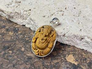 Hand carved Ganesh pendants, tigers eye with sterling silver mount and bail.  Dimensions 3.7 x 1.7 x 0.7 cm