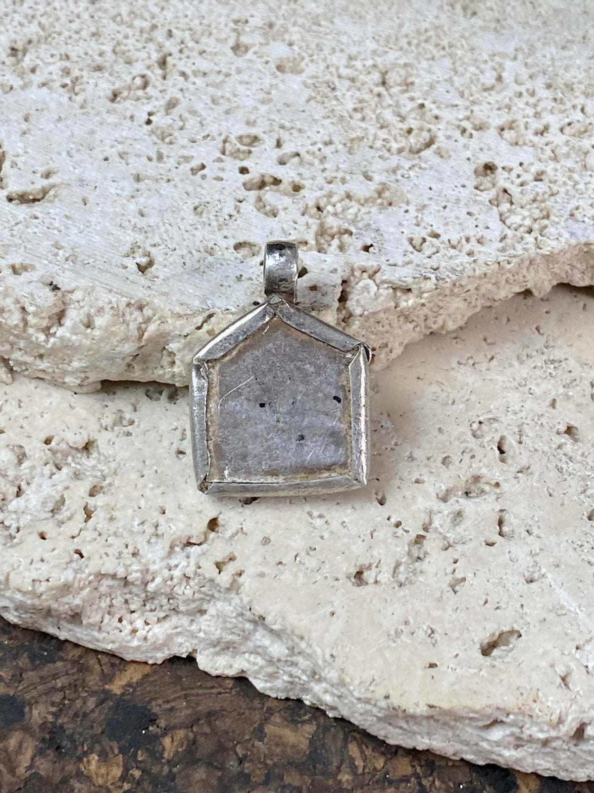 antique tribal amulet depicting Durga in Kali form. High grade silver with a 22 kt gold finish over the amulet face. Early 20th century or earlier. This is a unique amulet in its depiction of the goddess in tribal headdress and its use of silver and gold.  Height 2.7 cm including bail, width 2 cm