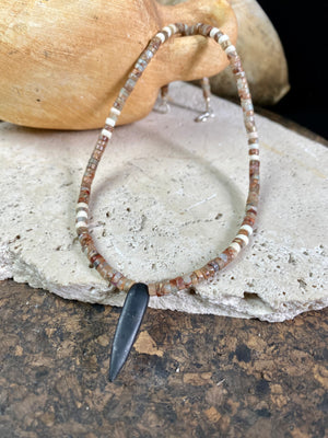 This unique necklace is made from heshi amazonite quartz druzy beads, highlighted with Kachin Burmese shell beads and a pendant made from unpolished onyx. Finished with sterling silver findings and hook clasp. Our necklace will look great on either men or women. Measurements: length including clasp 43.5 cm (17”)