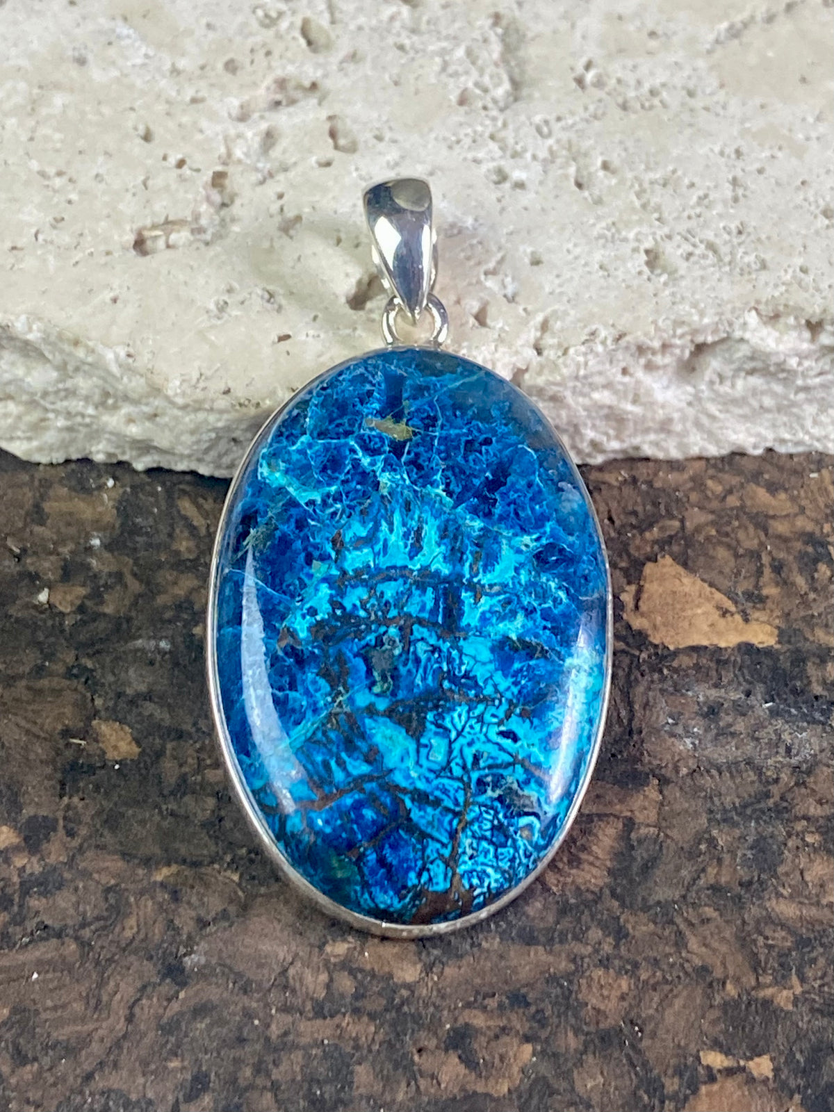 Unusual and striking azurite pendants. Set off by sterling silver bezels, topped by generous sized bails large enough to accommodate a thick chain or cord. If you're looking for something a little bit different, these pendants are stunning.