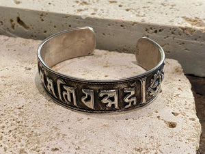 Sterling silver Buddhist Om Manu Padme Hum bracelet. This is a large and substantial men's silver cuff  This beloved Buddhist mantra translates to “hail, jewel in the lotus” and is the prayer of the Compassionate Buddha Avelokitsvara.