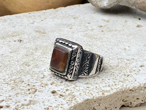 An elegant ring featuring a beautiful dark carnelian stone. The stone shows some wear commensurate with its age. Afghanistan, early to mid 20th century. Can be worn by either men or women. Measurements: Ring face 1.6 x 1.3 cm, inner diameter 18.5 mm | Size 8.5 | No 19