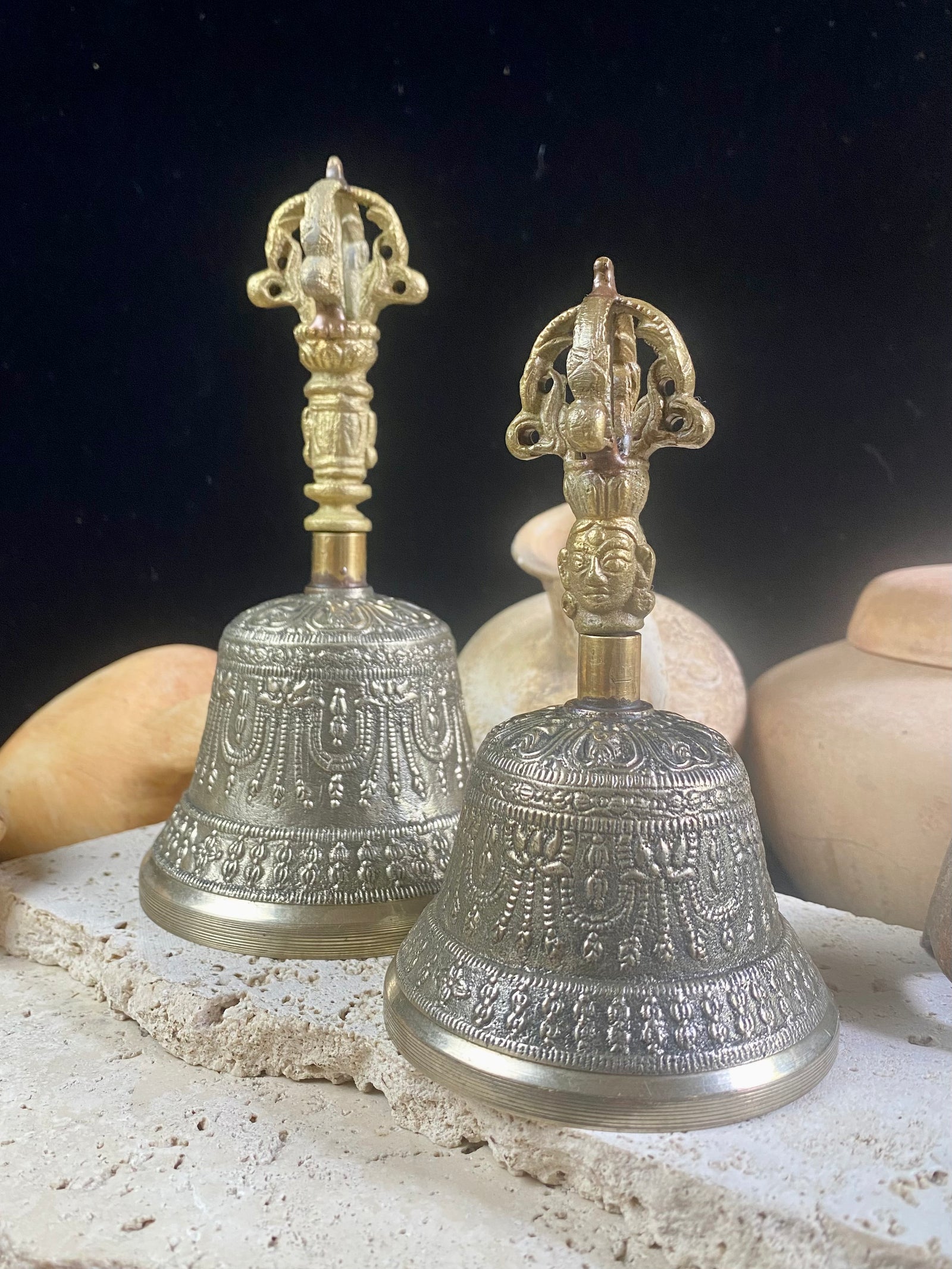 Tibetan Buddhist bells in two sizes. They feature fine detailing, are encircled with the mantra Om Mani Padmi Hum and are topped with the image of the Buddha and the dorje. These very high quality bells have a beautiful tone, the larger is deeper and richer, the smaller is higher and sweeter. Please watch our two videos to hear their sound.  Measurements:  Large: height 16 cm, diameter 9 cm Small: height 13 cm, diameter 7.5