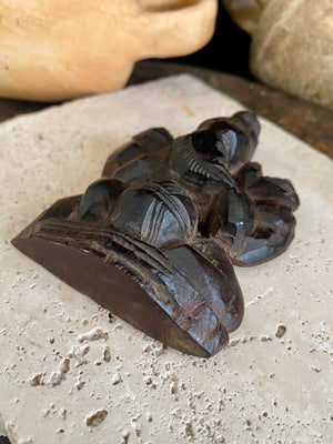 Small rosewood carving of Ganesh. Early 1900's, from east India. Two arms, seated, with his trunk to the left.  Height 9.5 cm, width  7 cm