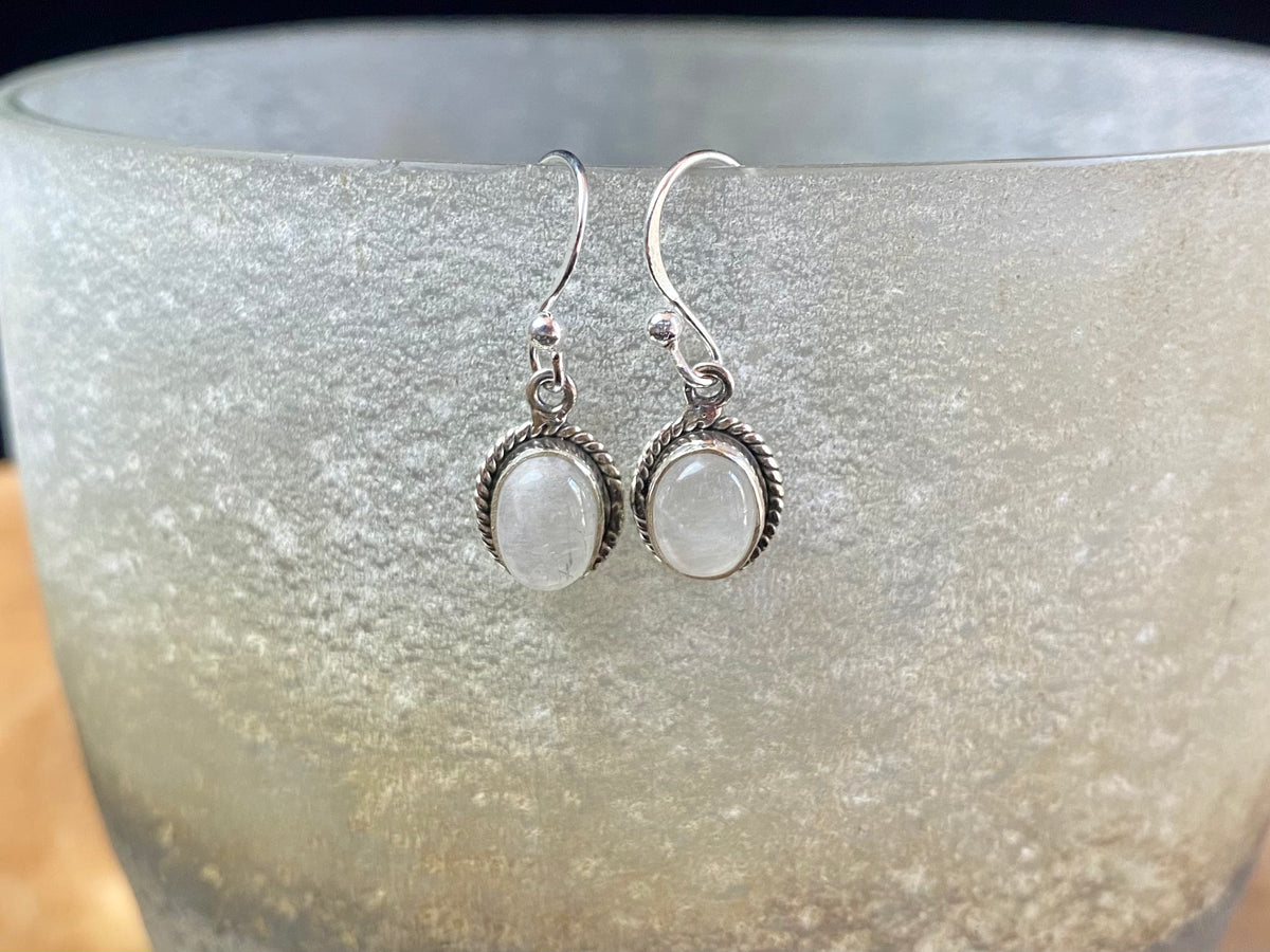 Elegant oval shaped earrings with a beautifully detailed bezel to show off the natural beauty of the cabochon stones. Sterling silver hooks complete the look. Our earrings are open-backed to allow natural light to show through. Length including hook 2.5 cm