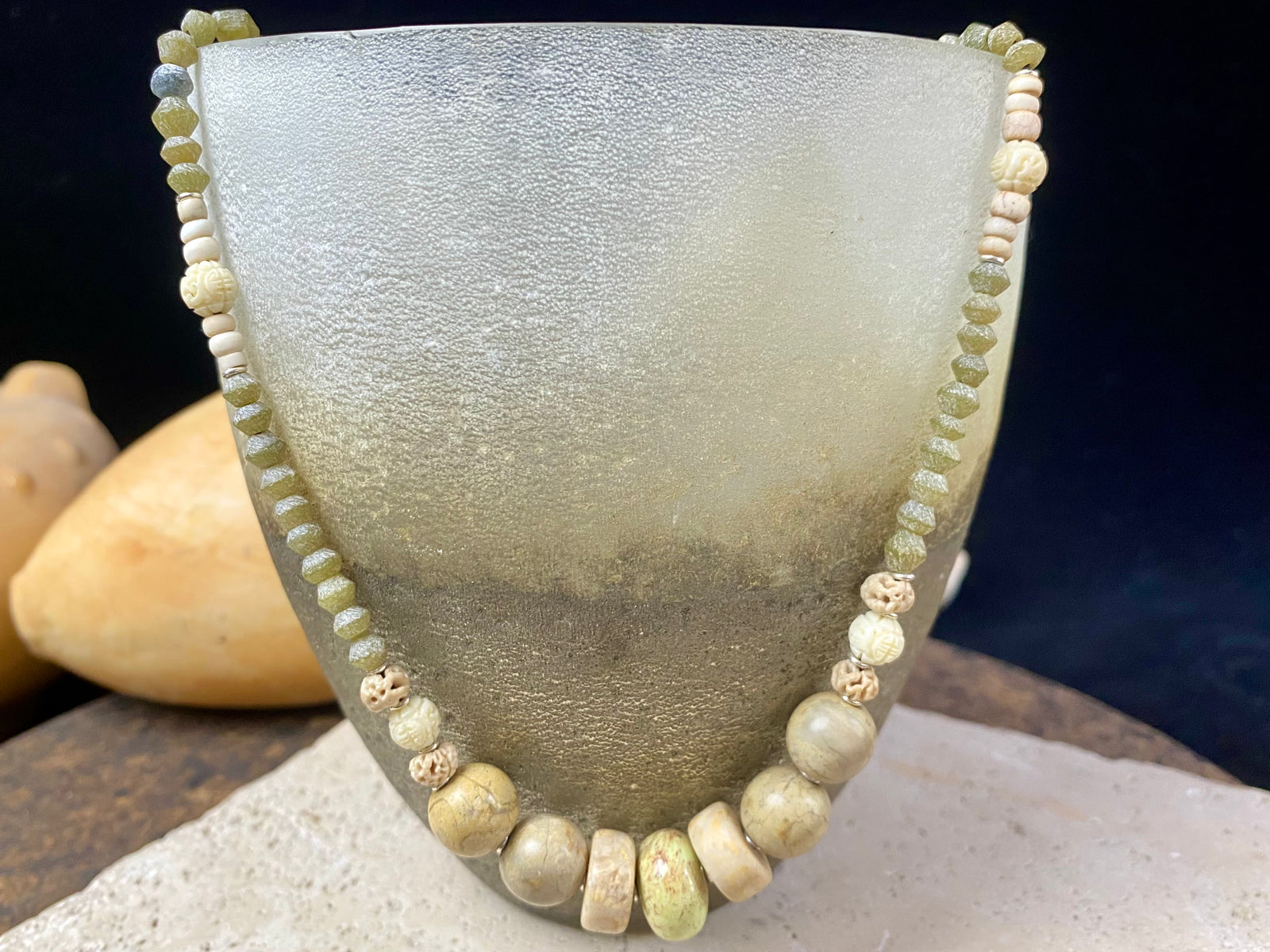 Tribally inspired stone necklace featuring prehnite, jasper, lotus root, carved white coral , glass and sterling silver.  Length 39.5 cm
