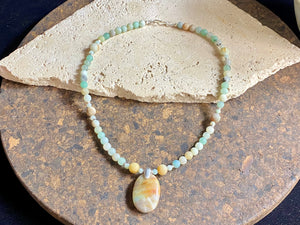 Unique necklace features matt amazonite beads highlighted with an amazonite pendant in the same shades of blue, white and pale red, mounted with a silver bail. Finished with sterling silver. Measurements: length 45.8 cm, pendant length 4 cm