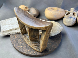 Old Oromo tribe wooden headrest from Ethiopia. Carved from a single piece of wood. Pre 1950. The patina and wear on this piece are appropriate to its age. In particular, note that the upper surface is darkened from use and the leading front edge is both lower than the rear edge and is also smooth from use.