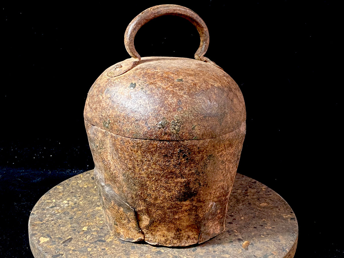 Antique camel or elephant bell, very large, one of the largest we've ever seen. This genuine old piece dates to the early 20th century and has a deep, melodic tone when rung. From Rajasthan, north India. Iron Measurements: Diameter at widest point 16 cm, height including handle 22 cm