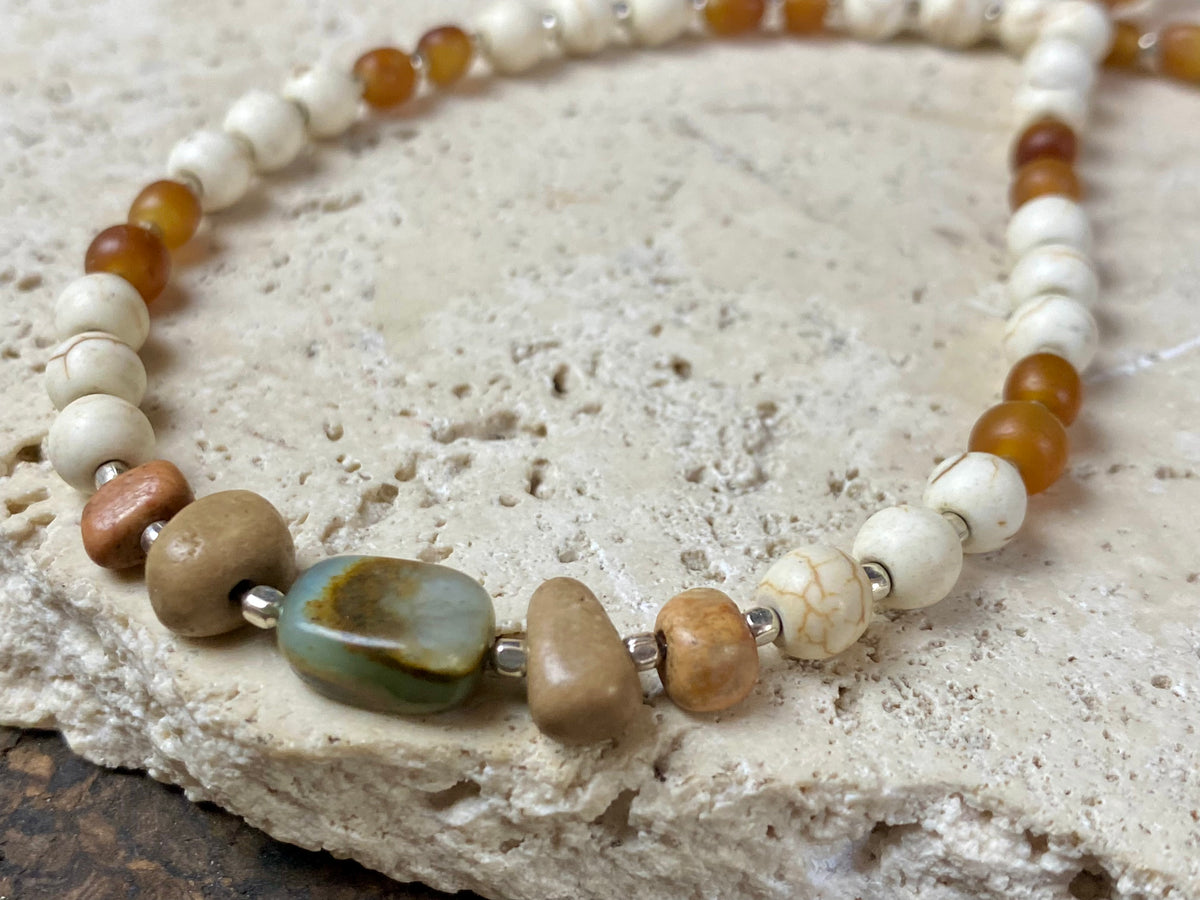 Our unique statement necklace features beautiful vintage beads from the Kashgar collection - turquoise centre bead, jasper beads from the Philippines, howlite beads, buffalo horn beads and  925 sterling silver detailing and lobster clasp. Length 45 cm.