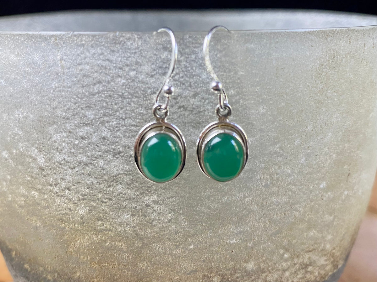 Simply elegant oval earrings with a small shadow box bezel to show off the beauty of the natural cabochon gemstones. Sterling silver hooks complete the look. Our earrings are open-backed to allow the light of the stones to show through. Length including hook 2.5 cm