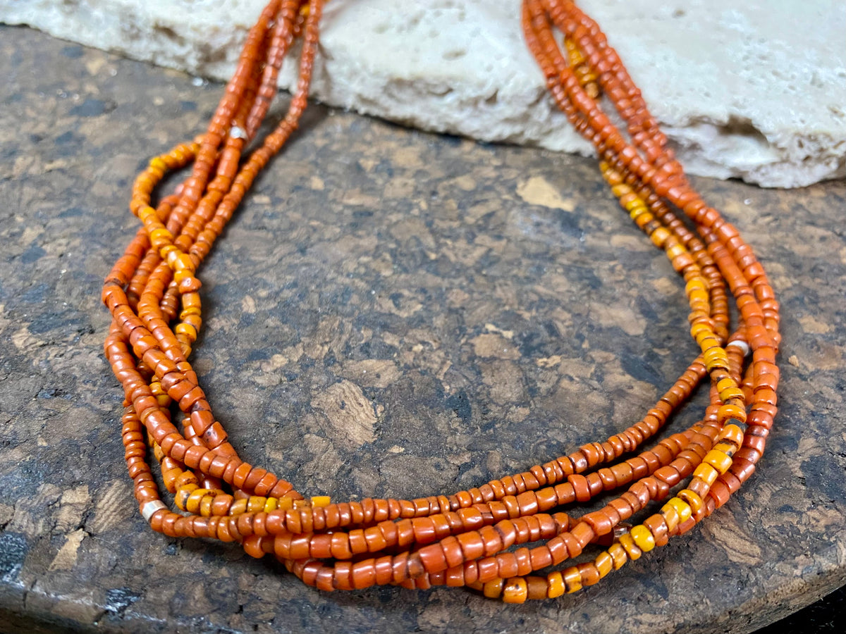 Our long tribal multistrand necklace is made with  antique ceramic beads worn by the Bonda people of the Himalayas. This five strand red-brown-orange necklace is finished with a handmade sterling silver clasp and features sterling silver bead detailing.   Measurements: 66 cm  length
