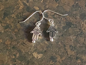 Stylish and very small hamsa earrings. The body of the earring is made from a non-tarnishing white metal indistinguishable from silver, while the pins and hooks are sterling silver. Lightweight and very easy to wear. Measurements: drop including hook 2 cm