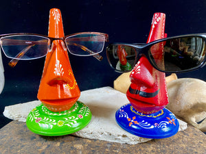 Always losing your glasses and sunglasses at home? We have the solution. Hand crafted from lightweight wood, these very cool little guys are traditionally called chasma stands and they will make sure you never misplace your sunglasses or glasses again. From India Measurements: height 15 cm