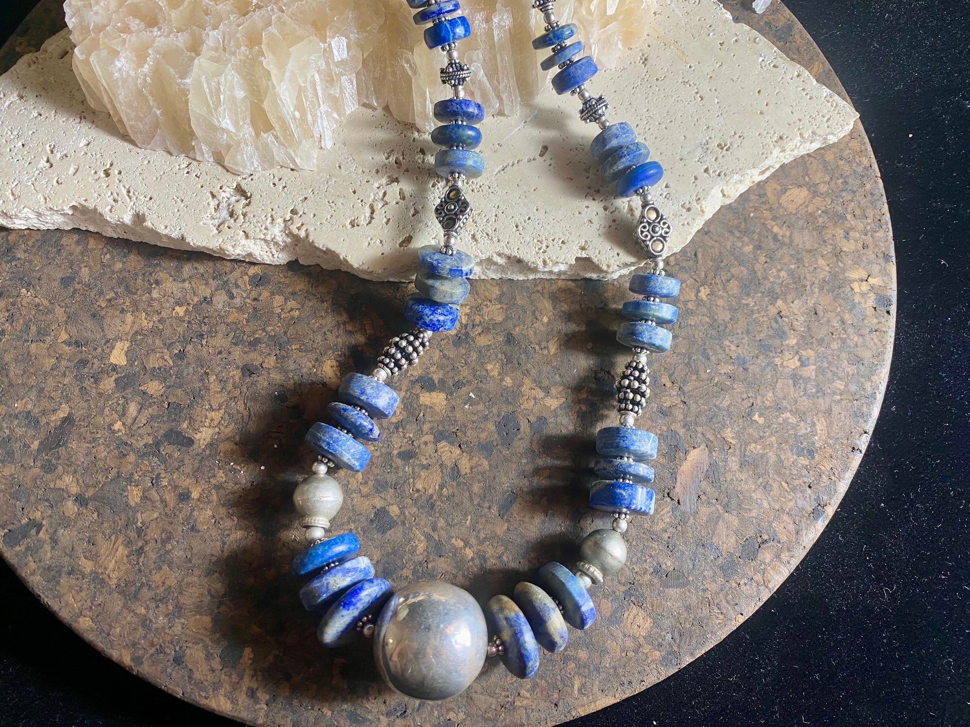 Tribal lapis lazuli and silver necklace, crafted from antique unpolished graduated Afghani lapis lazuli and handmade, vintage and antique tribal silver beads. This stunning, long necklace is finished with a sterling silver clasp and weighs 170 g. Measurements: 68 cm in length