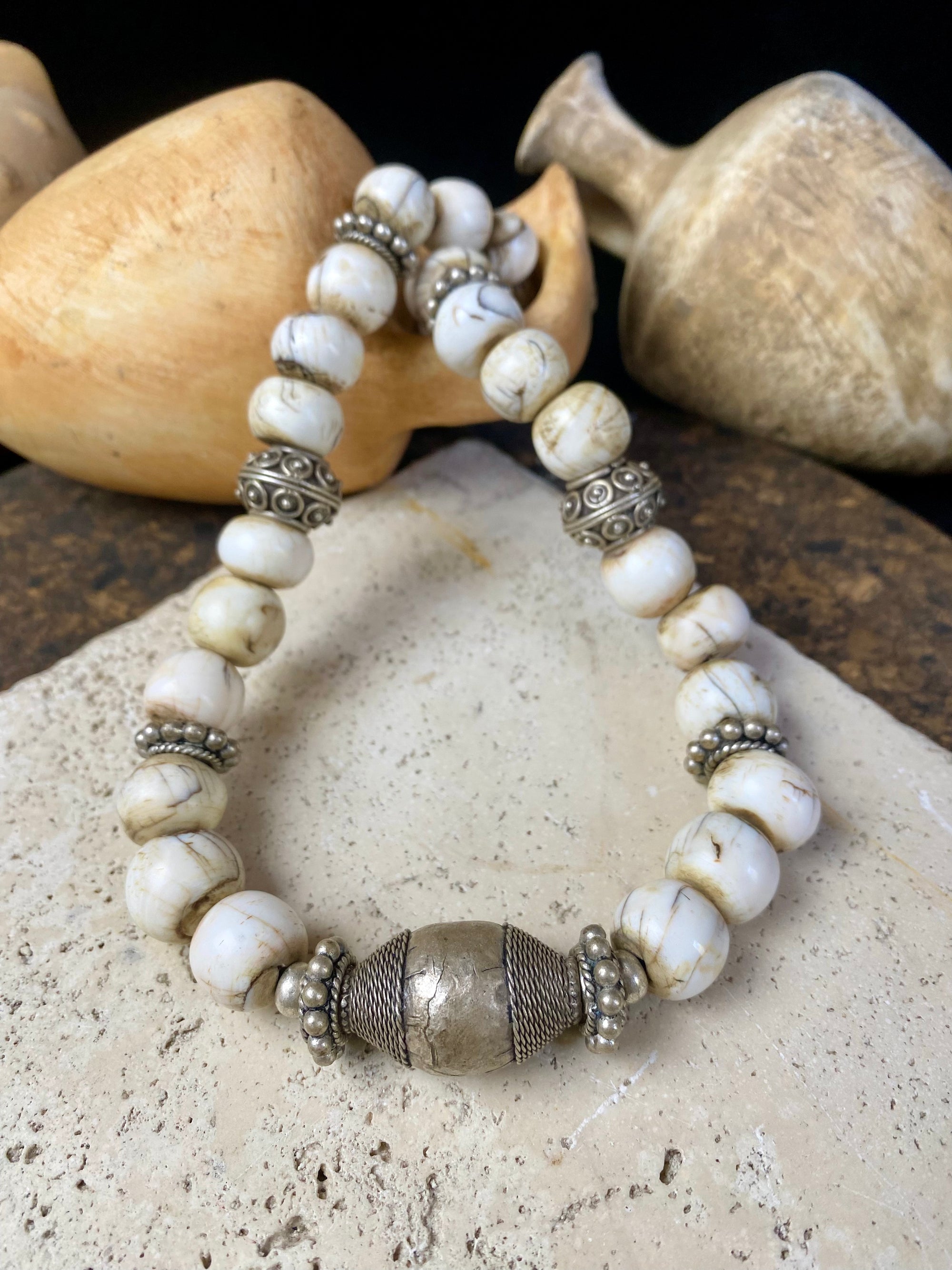 This statement choker necklace inspires Boho chic and features large antique Naga shell beads beads, vintage Indian silver beads and a handmade sterling silver hook. The central bead is an old piece consisting of hand wrapped silver over a wood frame. Length 48 cm