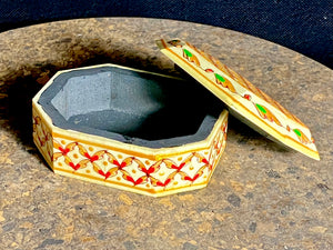 A compact trinket box, hand crafted from wood overlaid with polished hand shaped panels of camel bone, which are then exquisitely hand painted. Measurements 10 x 8 cm, height 4 cm