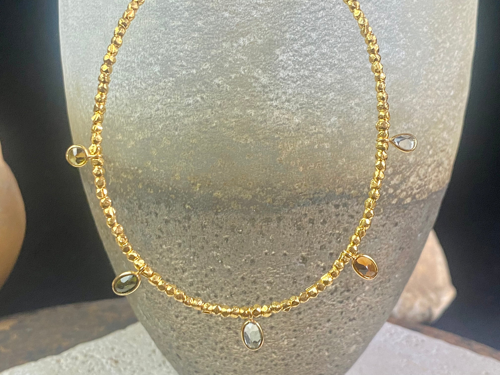 Vibrant gemstones adorn this elegant multi charm necklace. Plated 22k gold over brass, the multicoloured gemstones are evenly spaced and bezel-set to highlight the beauty of each gemstone. This necklace is designed to be worn short, but comes with an extension chain so you can set the length according to your neckline. Measurements: length 41 cm, with extension chain 45.5 cm