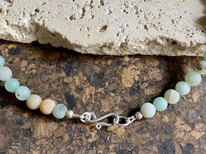 Unique necklace features matt amazonite beads highlighted with an amazonite pendant in the same shades of blue, white and pale red, mounted with a silver bail. Finished with sterling silver. Measurements: length 45.8 cm, pendant length 4 cm