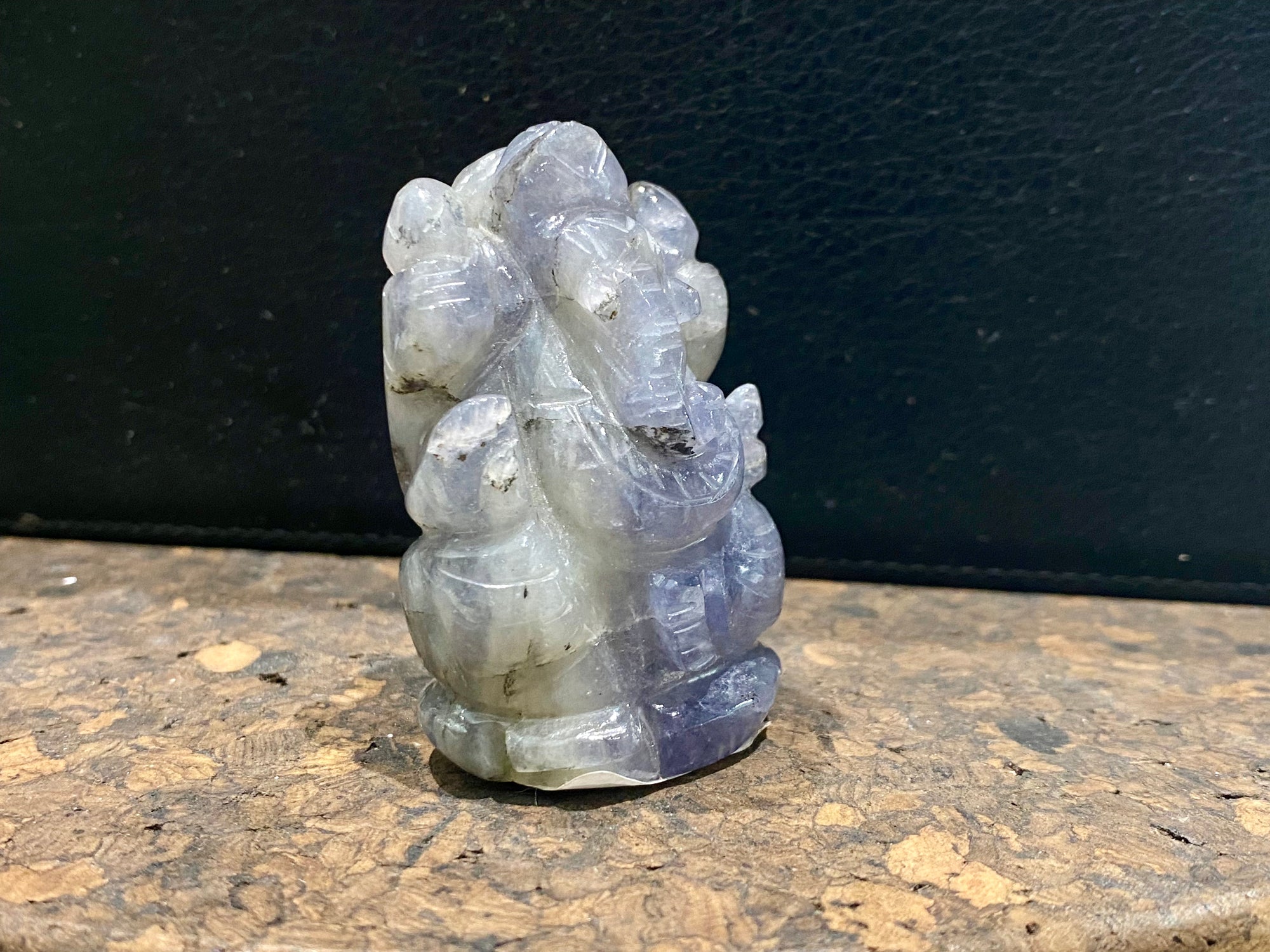 Hand carved from a solid chunk of iolite crystal, our Ganesha statue has a very contemporary feel. Ganesh is the lord of wisdom, remover of obstacles, patron of the the arts and new beginnings. Keeps unwanted influences from your door. Measurements: 5 cm height, width at base 3.5 cm