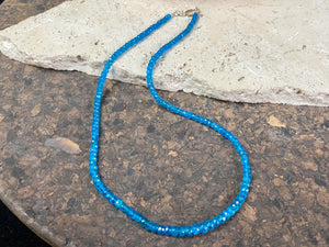 Short dark blue apatite necklace featuring graduated faceted apatite beads finished with a sterling silver lobster clasp. This is a lovely statement necklace that matches any skin tone or clothing. These stone are natural and not heat treated Measurements: 39.7 cm total length 
