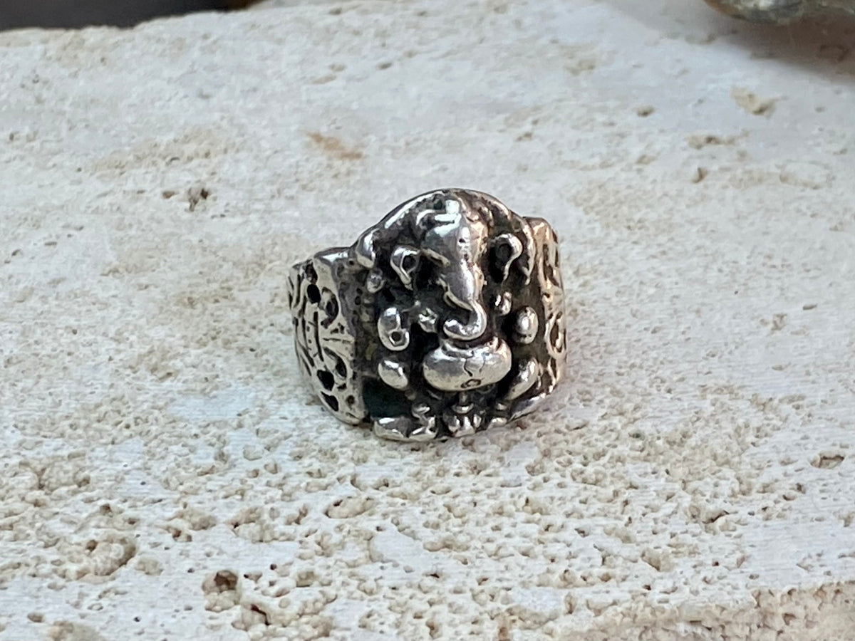 Vintage silver Ganesh ring from Rajasthan, India, weighing over 15 grams. A beautiful depiction of Lord Ganesha with small open piercings to each side of Ganesh and an image of the Tree of Life on the back. This is a stunning silver ring that can worn by men or women. Ganesh: 2 x 1.7 cm Size: 18.25 mm| Size 8