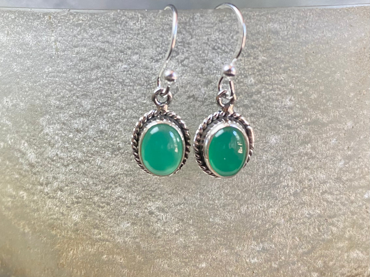 Elegant oval shaped earrings with a beautifully detailed bezel to show off the natural beauty of the cabochon stones. Sterling silver hooks complete the look. Our earrings are open-backed to allow natural light to show through. Length including hook 2.5 cm