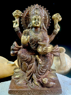 A statue of the goddess Laxmi (or Lakshmi), Hindu goddess of wealth and prosperity. Cast from solid brass, her features are exquisitely detailed, while her face, hands and feet are polished. Her right hand is raised in the gesture of protection and her left hand holds a pot symbolising abundance. Measurements: 19.8 cm height, width12 cm, depth 8.3 cm