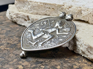 Leaf shaped amulet depicting Shiva in his form as Bheru , from the Bhil people of northern India. This amulet dates to the early 20th century or late 19th century and has its original double bail in place. From northern India. Very high grade silver.  Measurements: total height 5.8 cm including bail, width 4.2 cm at widest point.