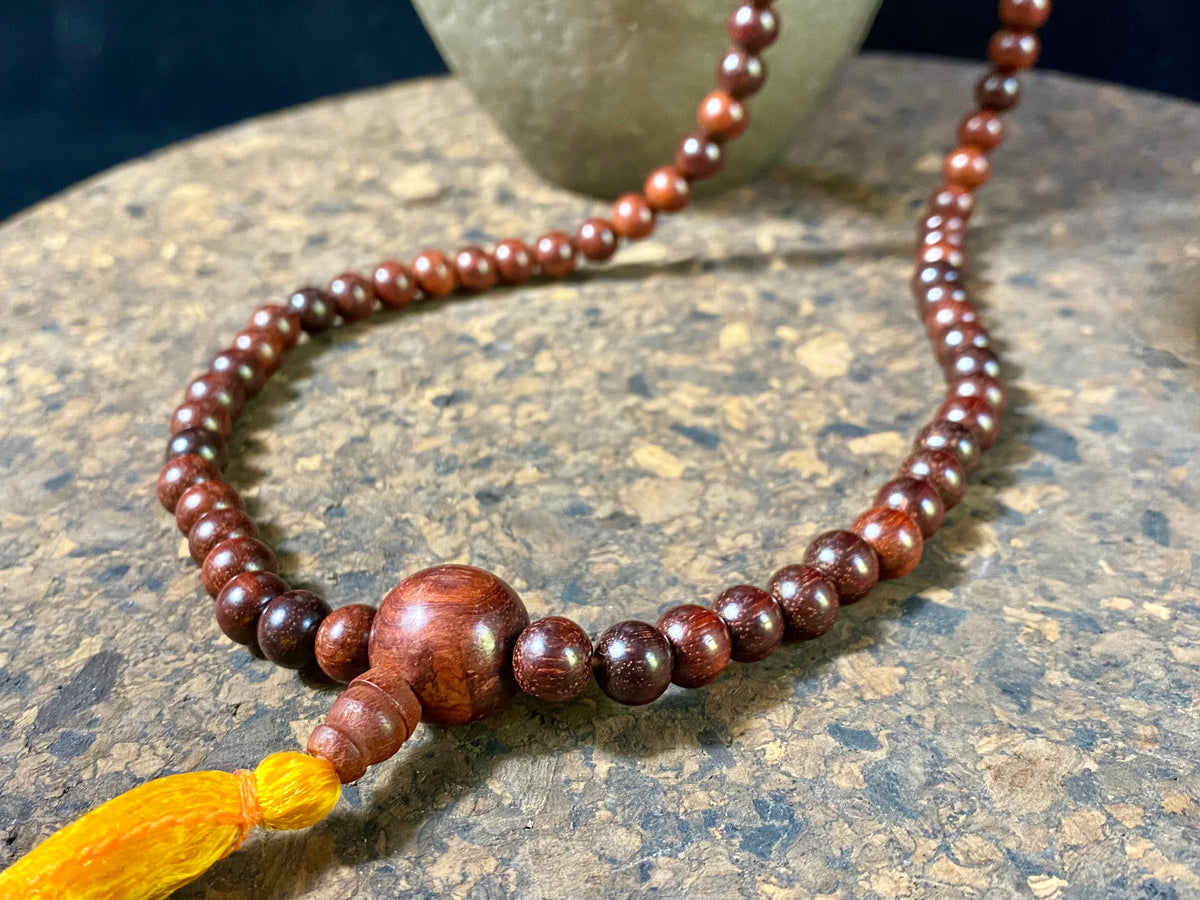 Women or men’s mala necklace, made from natural, dark sandalwood. This beautiful mala is exceptionally well made and has a pleasing lustre, weight and feel in the hand. As per a standard Buddhist mala, it contains 108 beads. From India