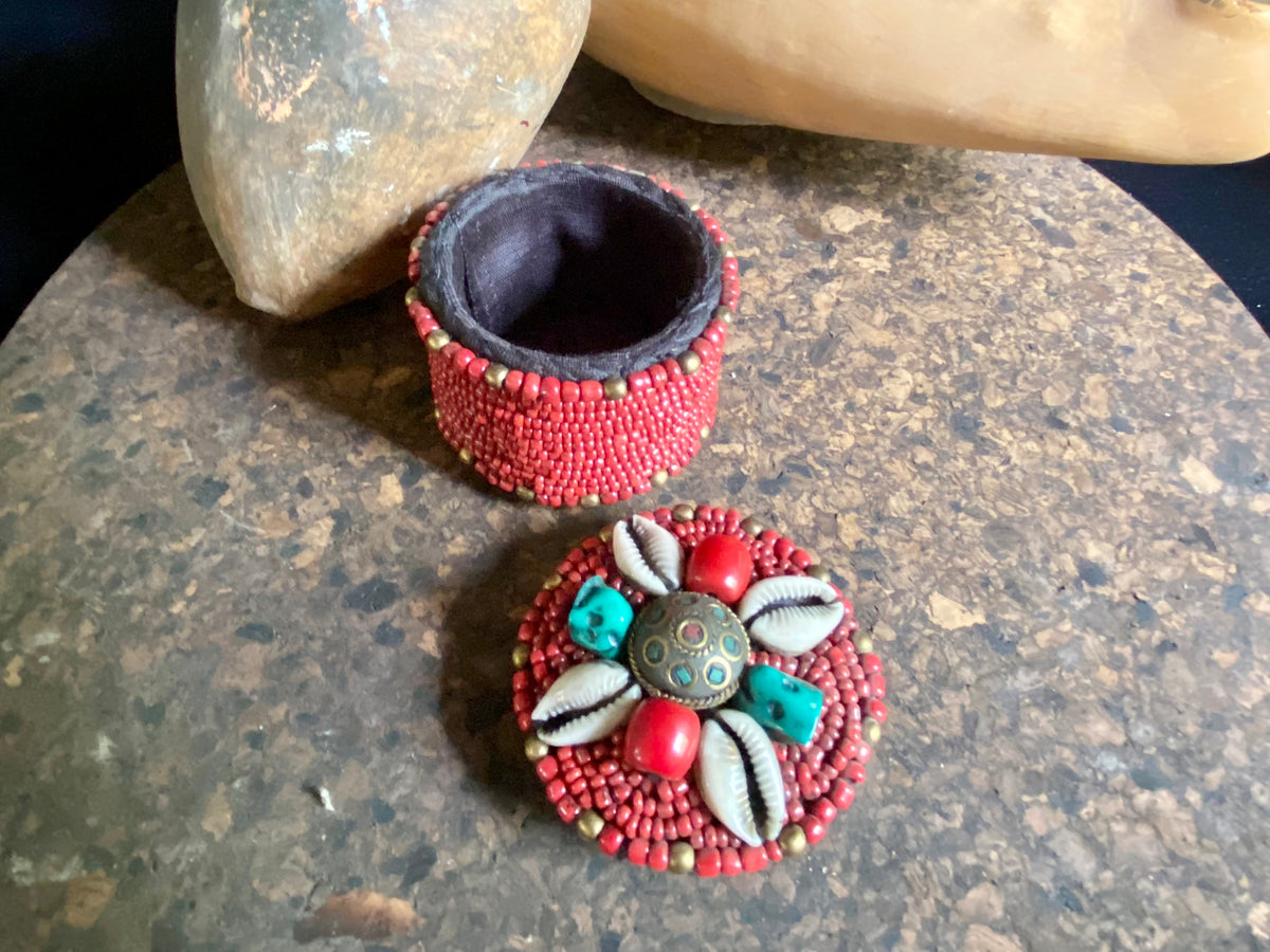 Sikkim ceramic bead work adorning a small trinket box. Soft fabric interior. Measurements: 6 cm diameter, 6 cm height.