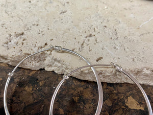 Hand made sterling silver flat hoop earrings with silver wire detailing. If you're looking for a pair of hoops that are elegant and a little different, you're going to love these.  Measurements: outside diameter of hoop approximately 5 cm
