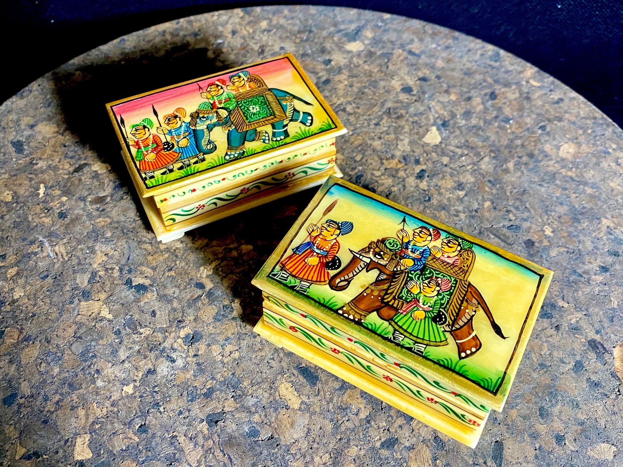 Small perfectly formed trinket or pill boxes, hand crafted from polished hand shaped panels of camel bone, which are then exquisitely hand painted with scenes of elephants. Set on small feet for real elegance. Length  7.5 x 4.5 cm, height 3 cm