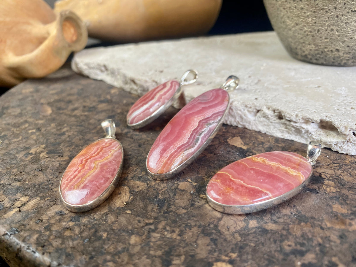 The most beautiful rhodochrosite we've ever seen. Every piece tells a story, all set in sterling silver bezels with generous bails to take the largest of chains or cords. These are beautiful statement pieces of jewellery.