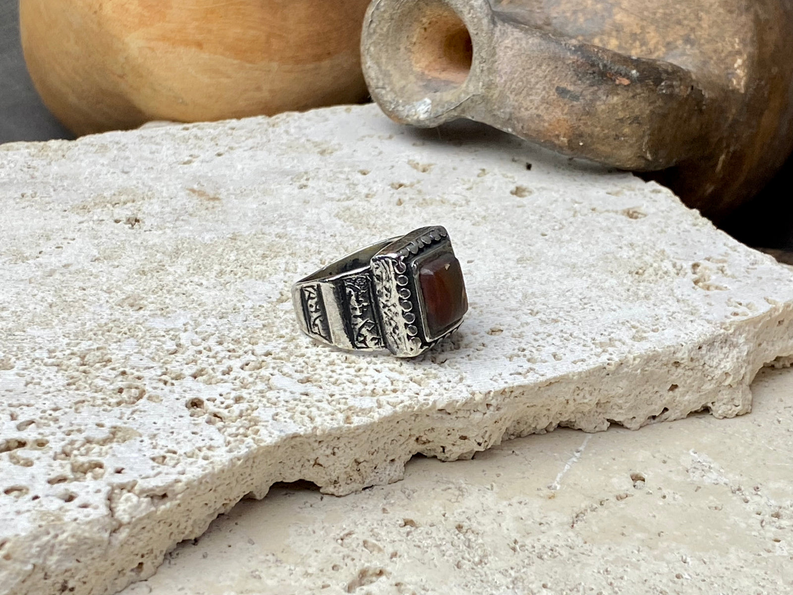 An elegant ring featuring a beautiful dark carnelian stone. The stone shows some wear commensurate with its age. Afghanistan, early to mid 20th century. Can be worn by either men or women. Measurements: Ring face 1.6 x 1.3 cm, inner diameter 18.5 mm | Size 8.5 | No 19