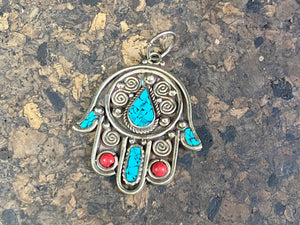 Beautiful hand made large hamsa pendant or charm set with ceramic turquoise and coral inserts. Non silver. Large bail for hanging. This is not just a piece for wearing around the neck. It can be hung anywhere you'd like it in the house. Height 5 cm