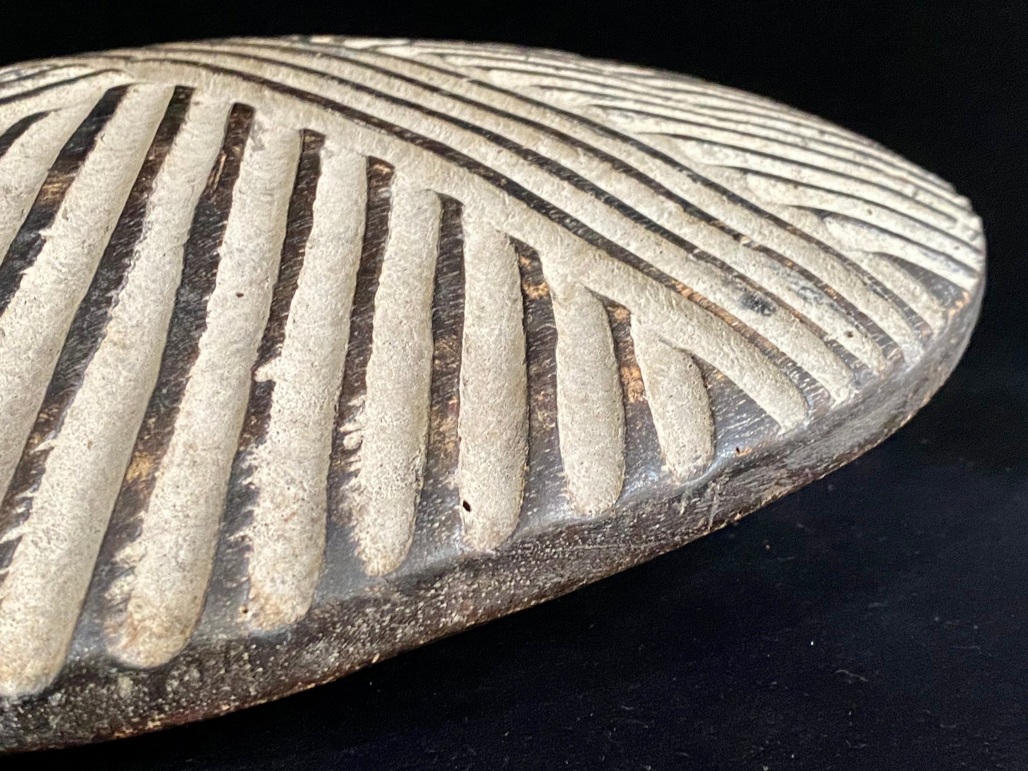 Round shield, Kuba people, vintage 1930's.  This shield features a patination of intersecting geometric lines and white pigment patina.  Measurements: diameter 42 cm, height approximately 6 cm