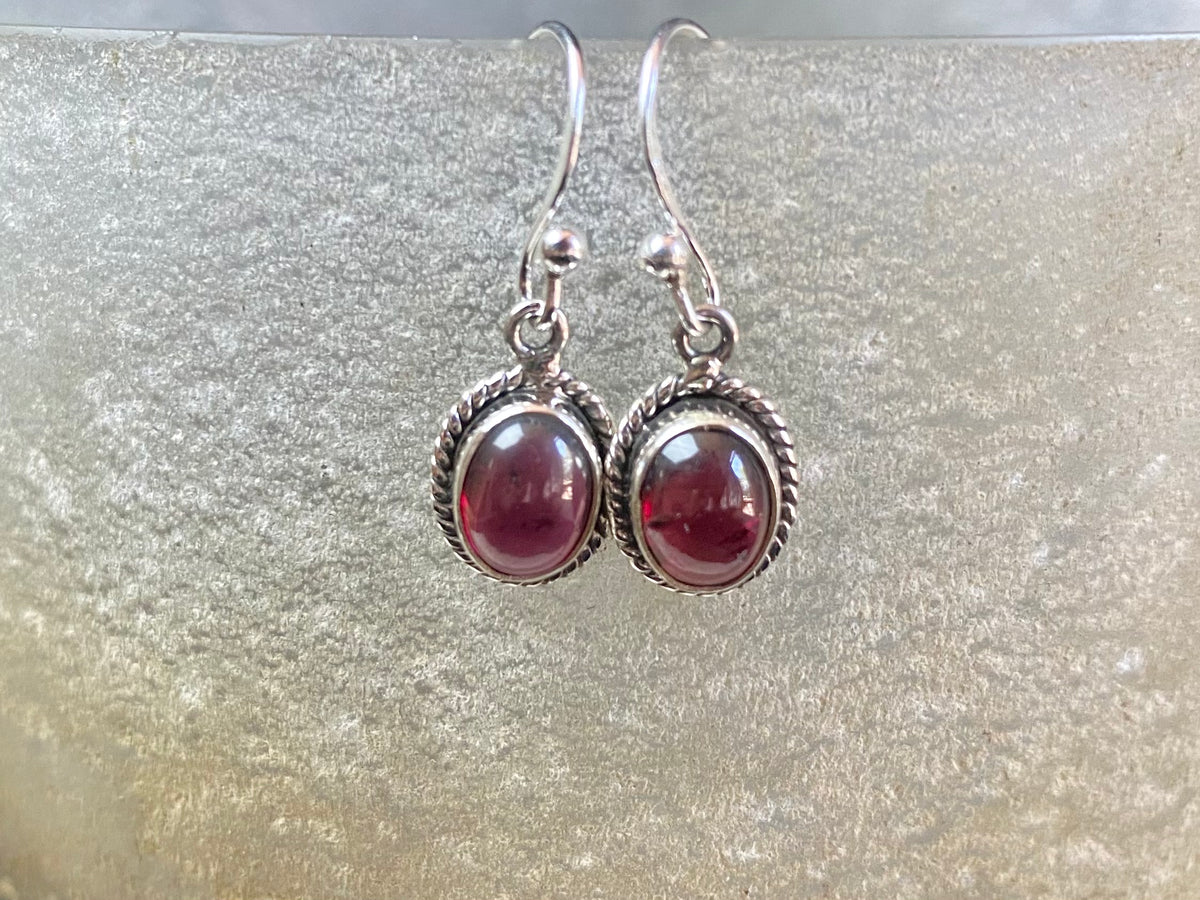 Elegant oval shaped earrings with a beautifully detailed bezel to show off the natural beauty of the cabochon stones. Sterling silver hooks complete the look. Our earrings are open-backed to allow natural light to show through. Length including hook 2.5 cm