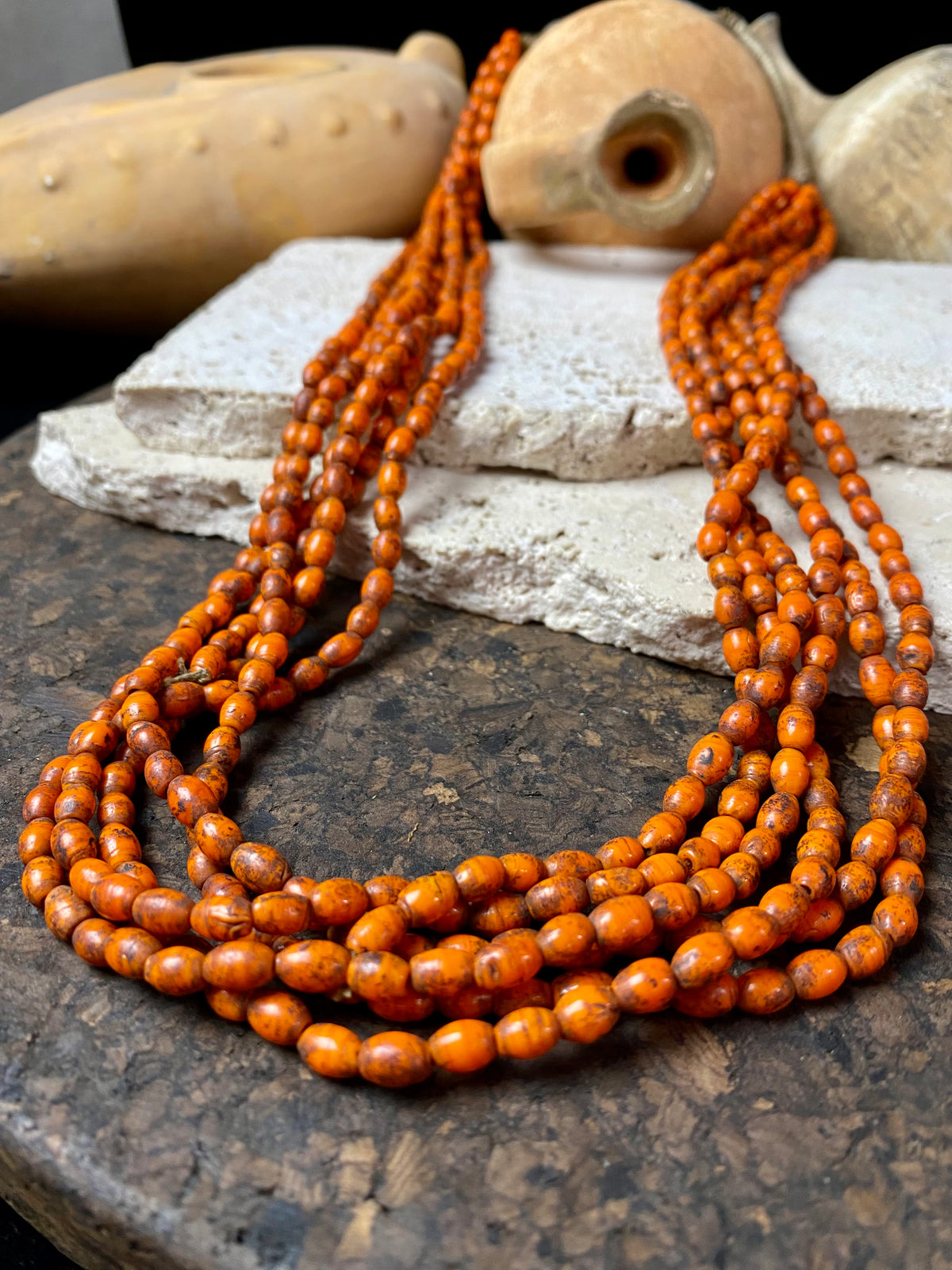 Vintage Naga long multistrand necklace made up of old ceramic beads with wrapped cotton ends and a coin button as fastener.  Measurements: 74 cm length