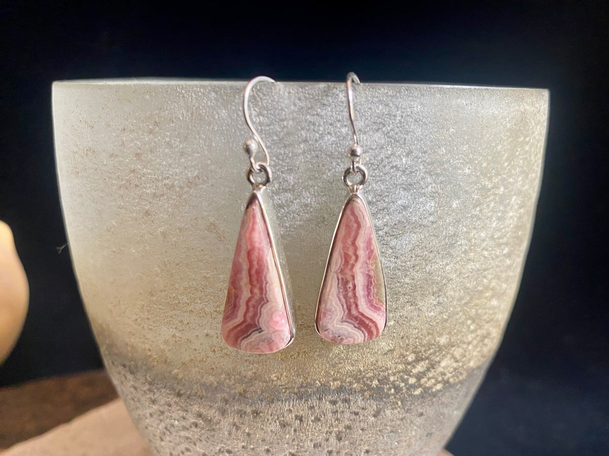 The most beautiful rhodochrosite we've ever seen. Every piece tells a story, and all earring pairs feature perfectly matched stones set in sterling silver bezels. Finished with sterling silver hooks.