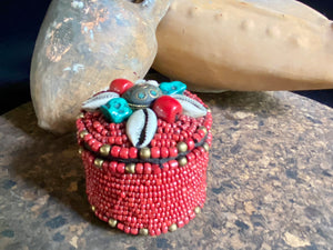 Sikkim ceramic bead work adorning a small trinket box. Soft fabric interior. Measurements: 6 cm diameter, 6 cm height.