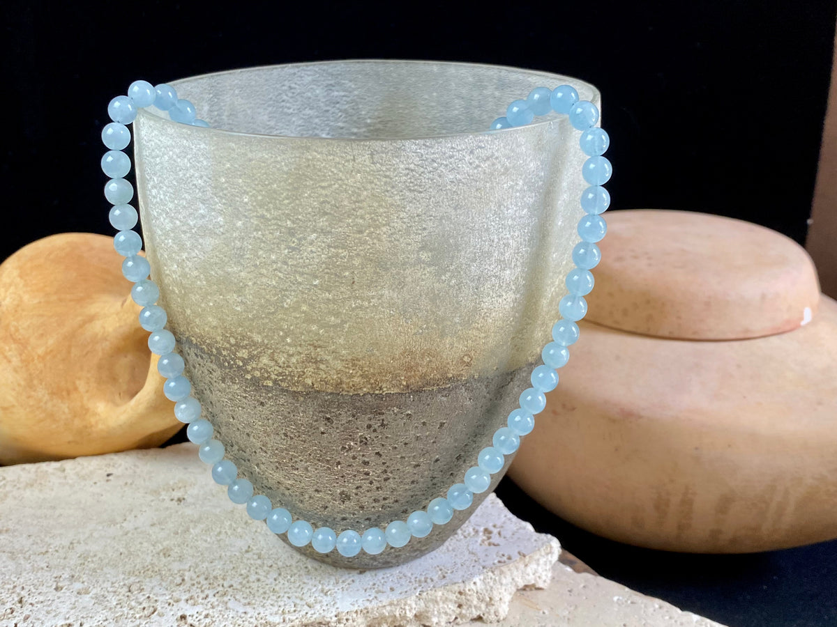 Natural aquamarine necklace featuring round aquamarine beads and a sterling silver clasp.   The aquamarines are matched a light and even blue of beautiful quality. Measurements: 47.5 cm